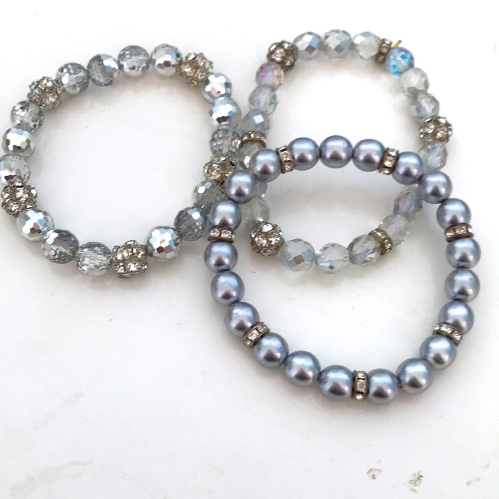Stack of crystal beaded stretch bracelets.